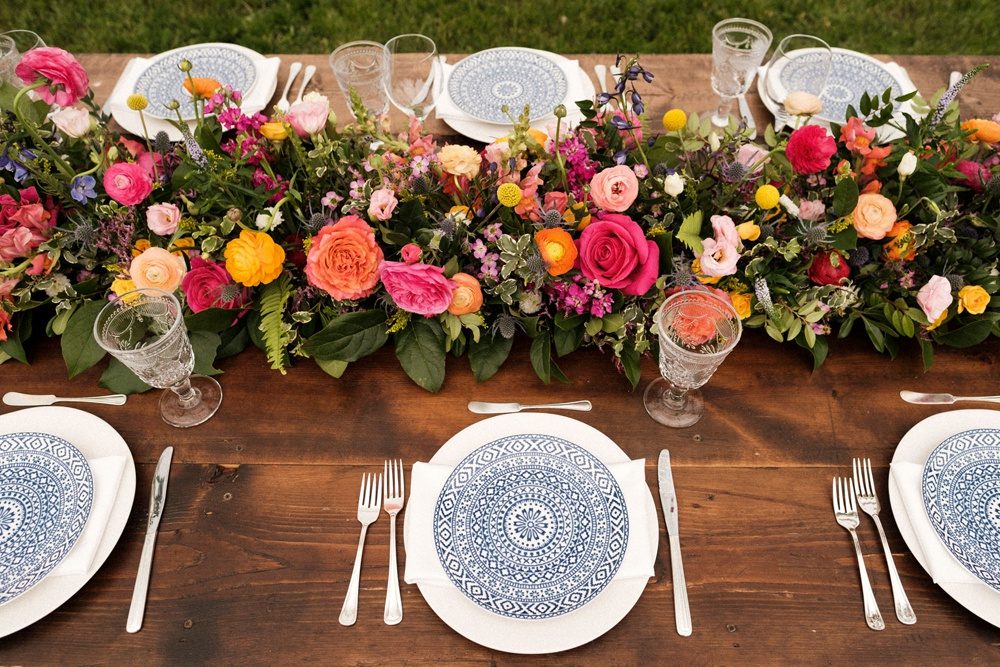Table settings, decor and vibrant flowers by Lumme Creations at a wedding in Boulder.