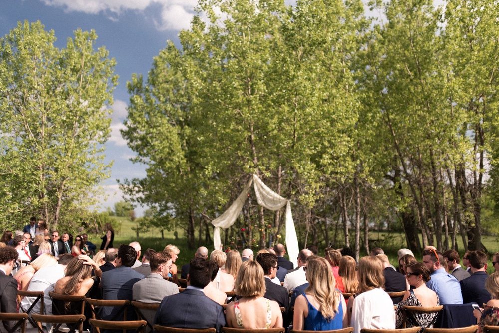 Guests gather for an outdoor wedding ceremony at Kelly Urban Farm in Boulder, Colorado.